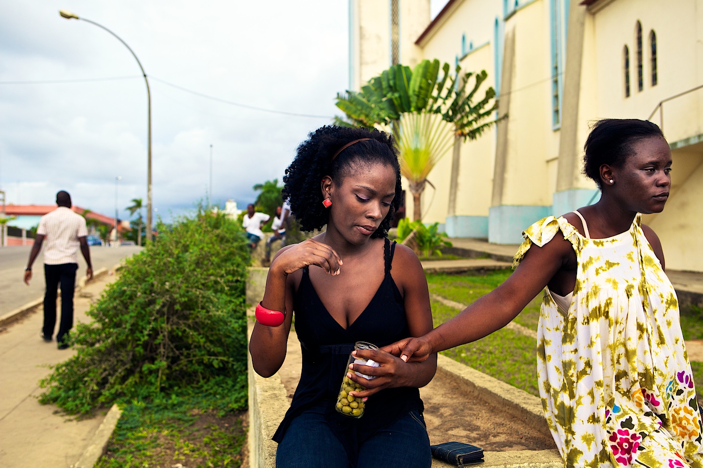 Girl eating a jar of Olives in Cabinda